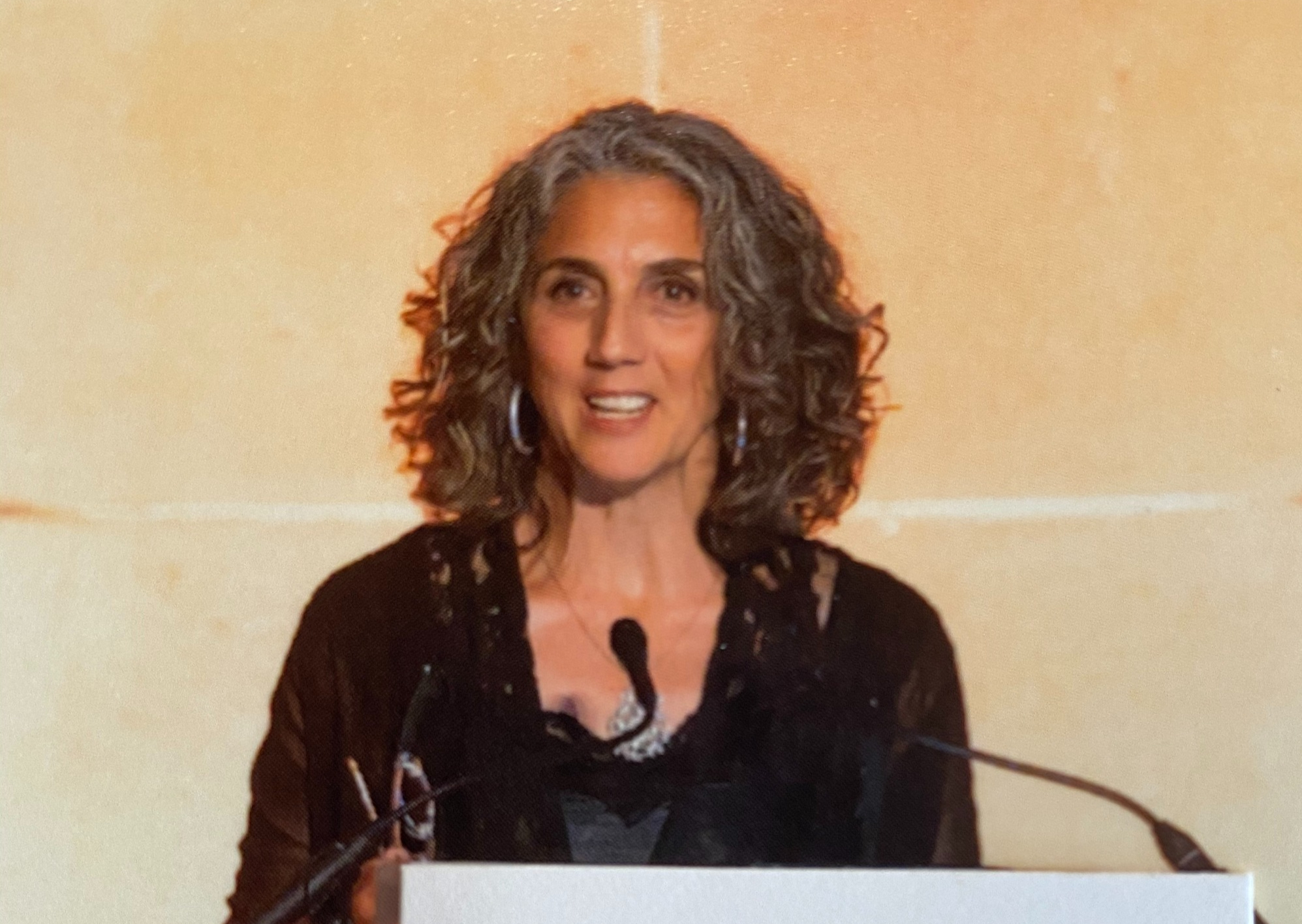 Ester Munt-Brooks speaking at a podium