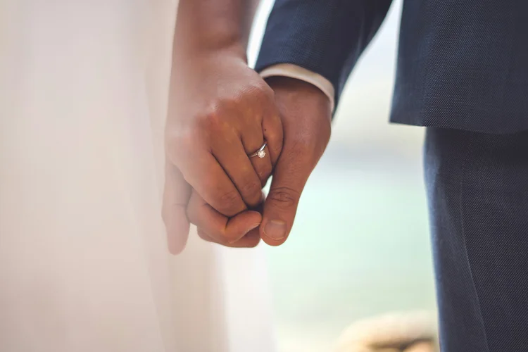 A married couple holding hands